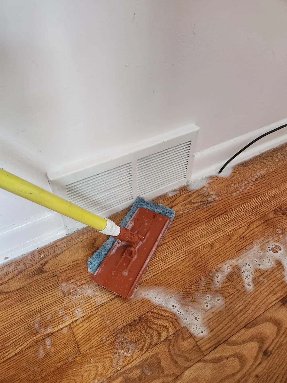 Hand tool finishing a floor edge where machines cannot reach