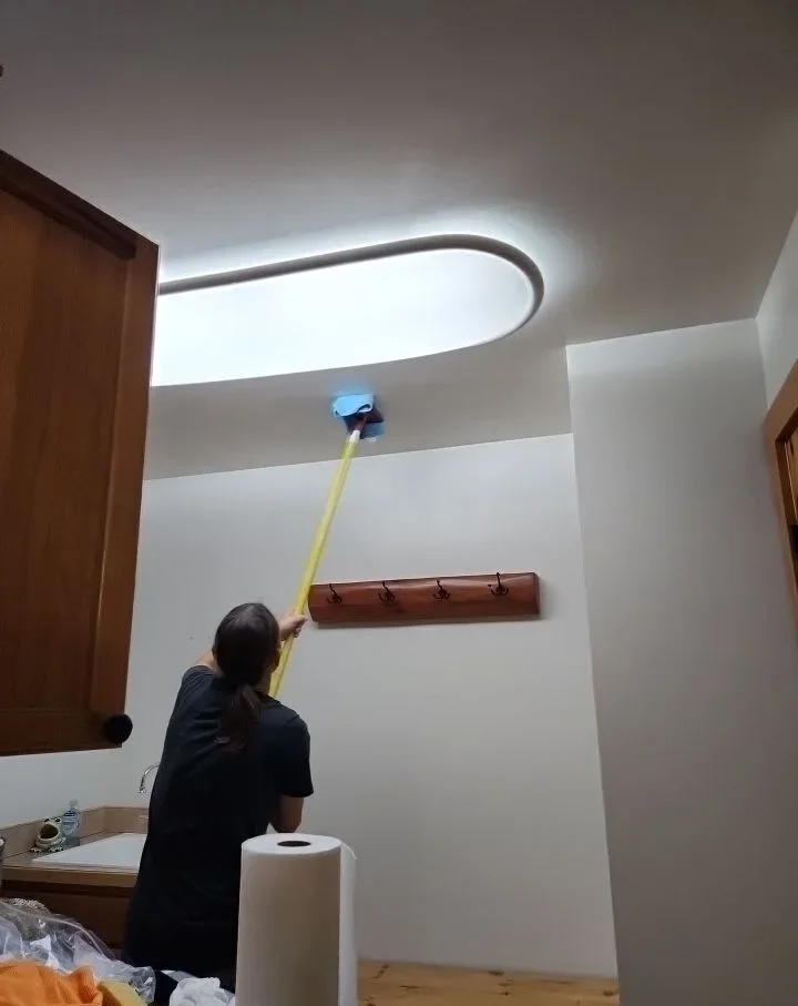 Technician detailing a unit ceiling during a turnover clean