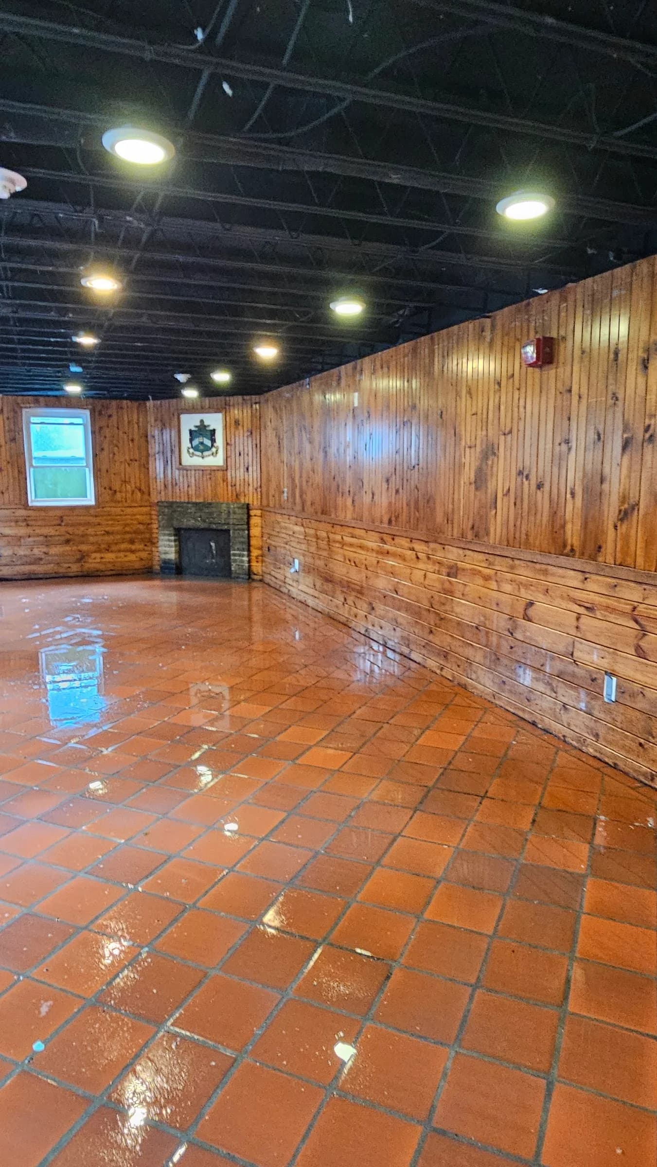 Restored wood-paneled interior with refinished floors in a historic Grass Lake area building