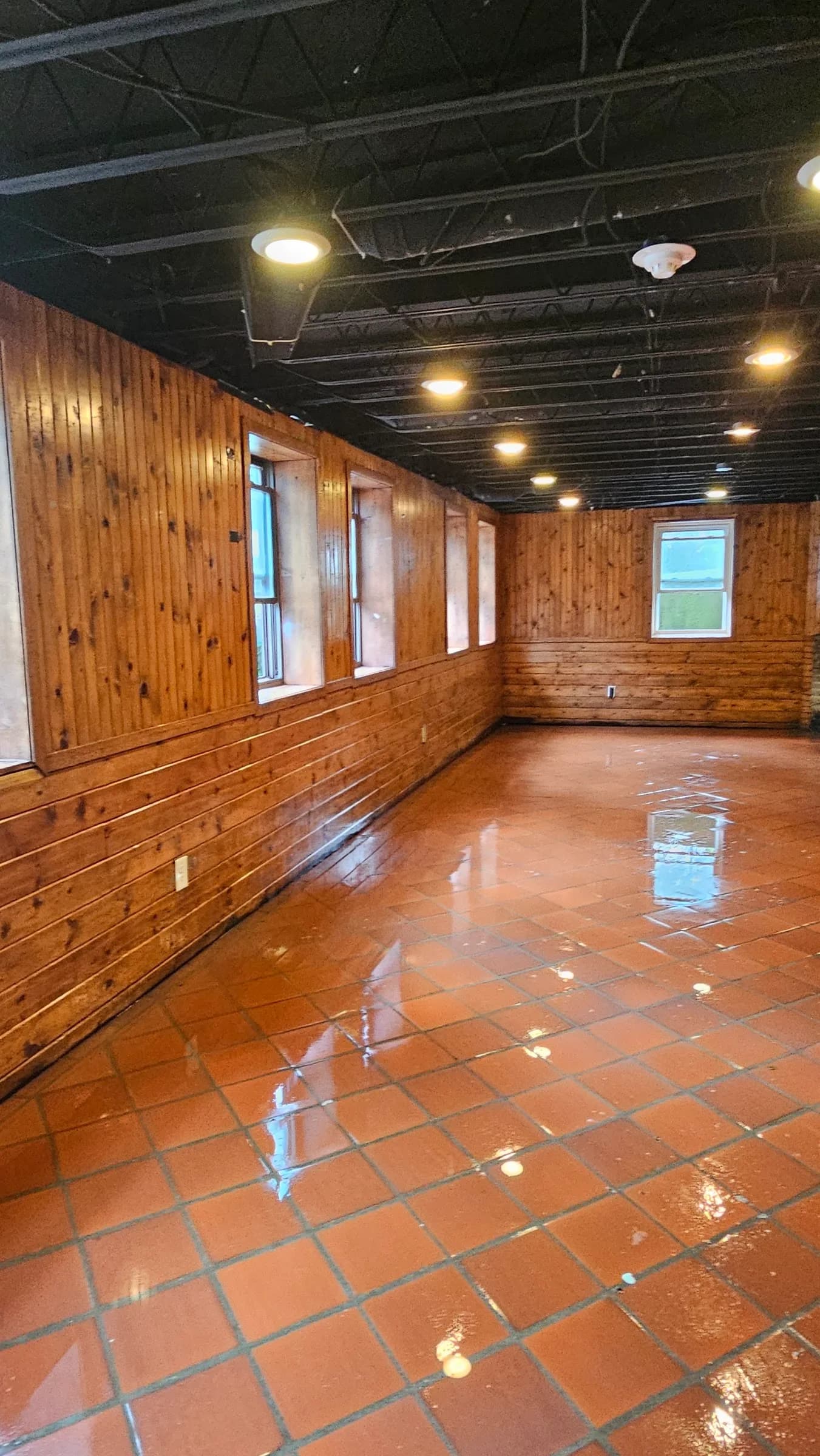 The same hall after restoration, floor cleaned and refinished to a shine