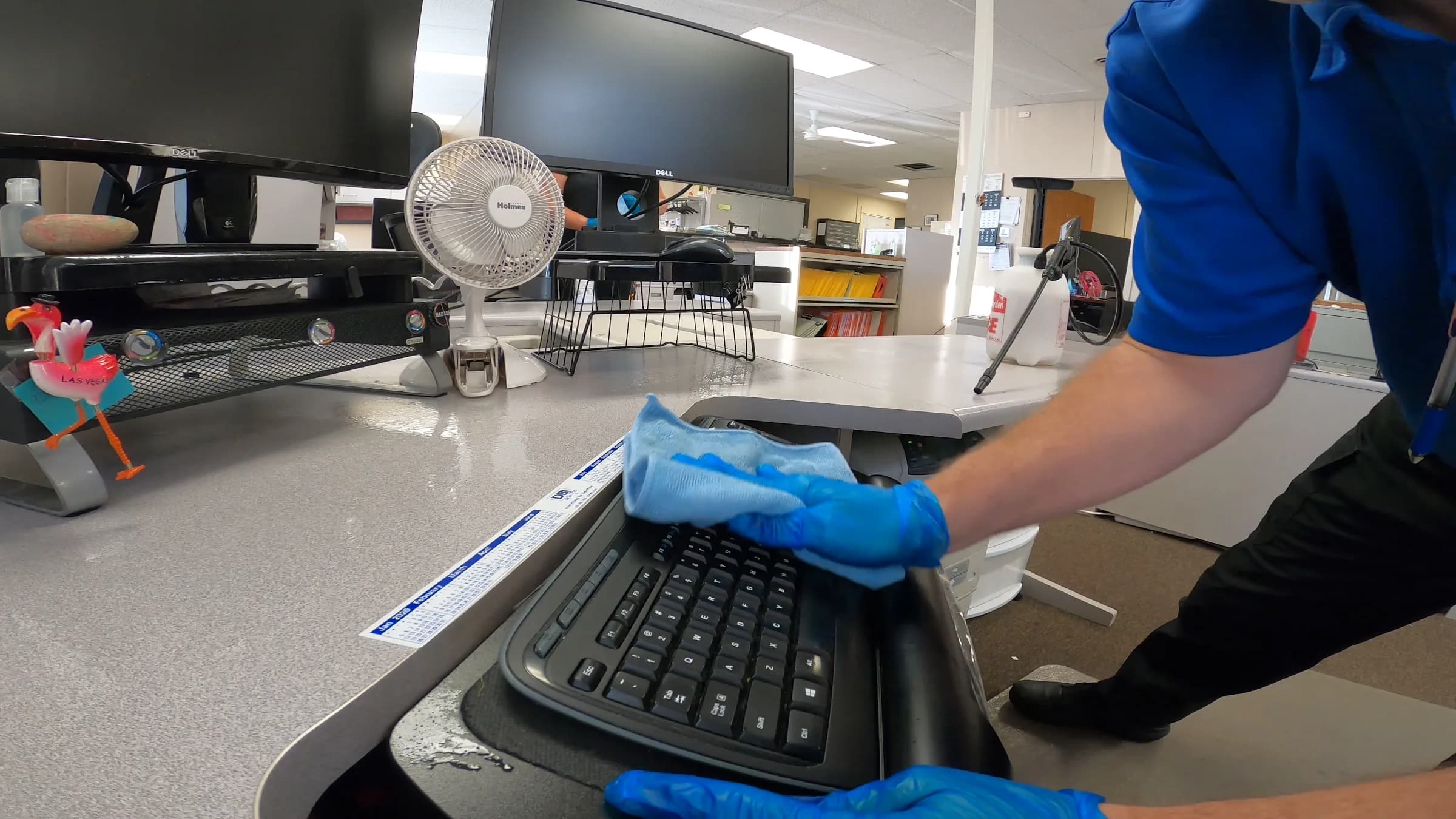 Technician detail-cleaning a Jackson office workstation
