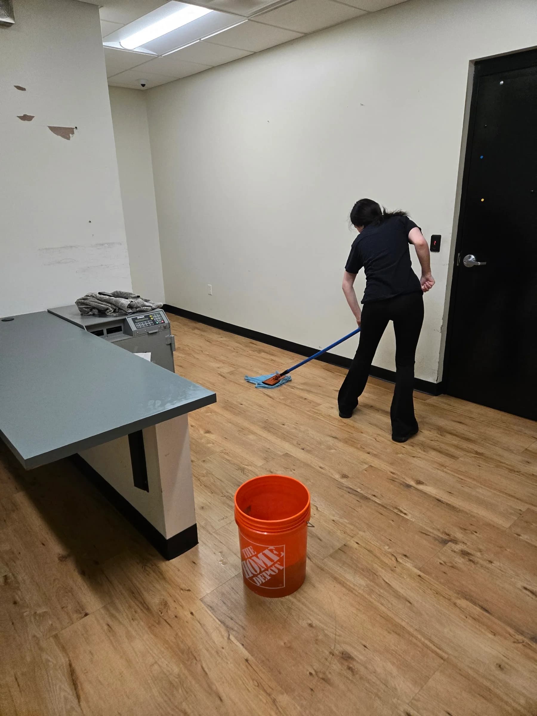 SWAT technician damp-mopping a commercial floor after hours in Jackson