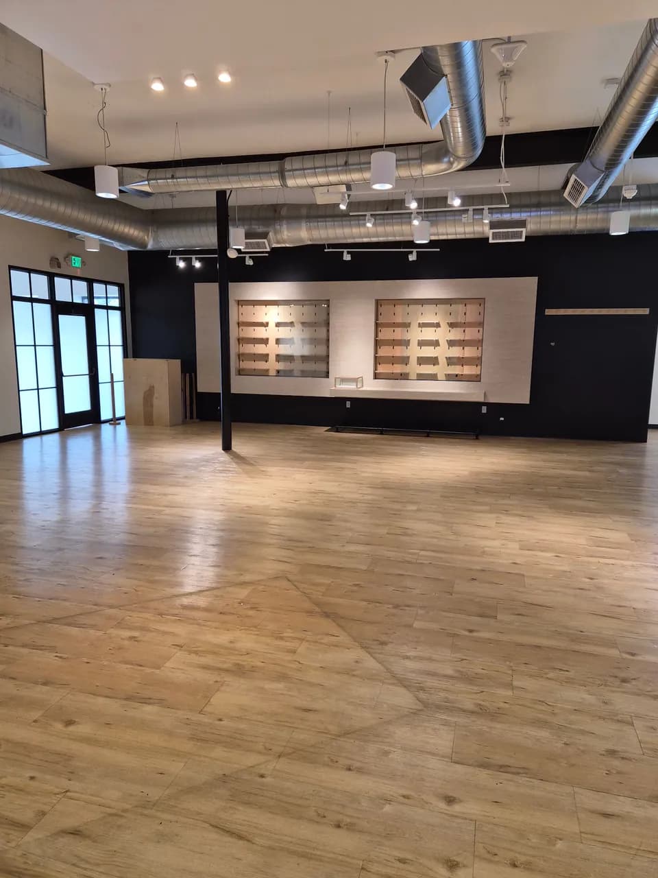 Retail showroom with wood-look flooring and wall display fixtures
